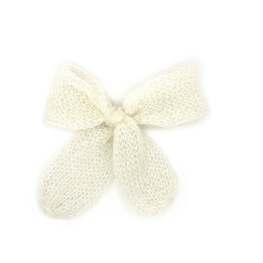 A white knitted mohair bow on a white background