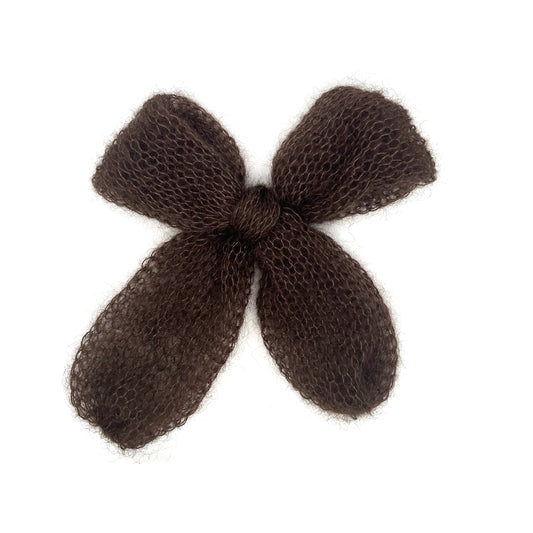 A chocolate brown knitted mohair bow on a white background