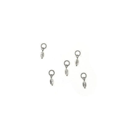 Oval charms with a flower pattern engraved into them hanging from 5 ring stitch markers for knitting. 